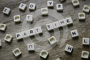 Part time word made of square letter word on wooden background