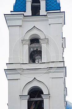 Part of the tower with the bell of the Christian Church of stone.