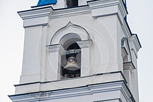 Part of the tower with the bell of the Christian Church of stone.