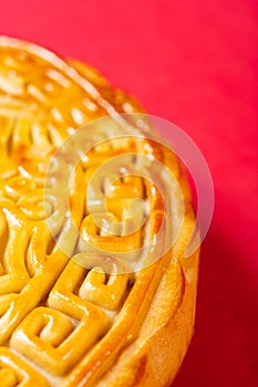 part of traditional Chinese mooncake on red with copy space vertical composition