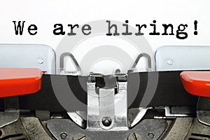 Part of typing machine with typed We are Hiring words