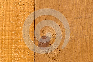 Part of uncolored rough wooden fence with oval shape knot. Textured. photo