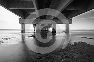 part under the Vasco da Gama bridge in perspective of infinity with the supporting pillars visible.