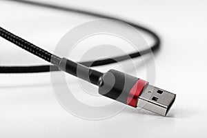 Part of USB wire with plug on white background.
