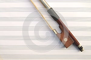 part of violin bow on staff paper