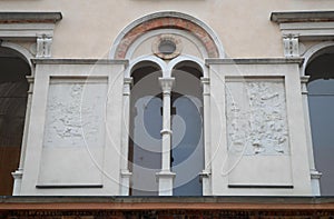 Part of a wall with arms of a building in front of the Cathedral of Crema in the province of Cremona in Lombardy (Italy) photo