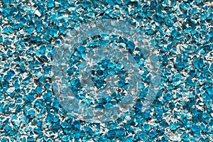 Part of the wall covered with small pieces of glass or quartz sea green or blue.