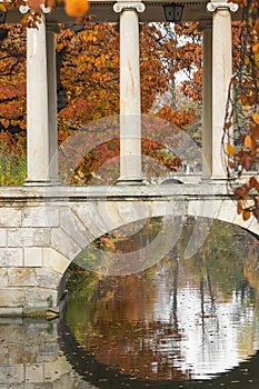 Part of white bridge with columns over the canal leading to the Royal Palace on the Water in Lazienki Park - Warsaw.