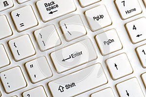 Part of a white keyboard for a computer. Enter key close up. Background for digitalization design and computer literacy. The