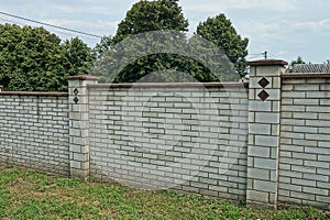 Part on white wall of brick fence