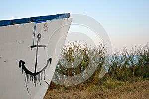 Part of a wooden boat with a anchore drawed