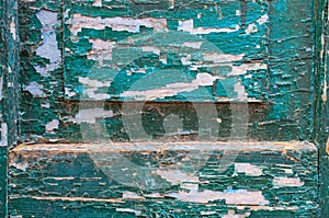Part of a wooden door with an old peeling paint. background