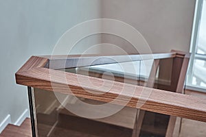 Part of wooden steps with glass railings. Walnut staircase