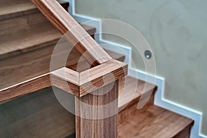 Part of wooden steps with glass railings. Walnut staircase