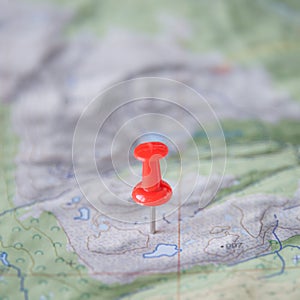 Part of the world topo map as ultimate item for successful travel and red push pin as location marker, abstract, background, paste