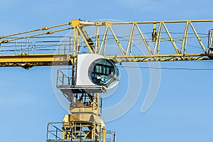 Part of yellow construction tower crane arm against sky