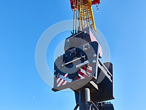 Part of yellow tower crane against blue sky