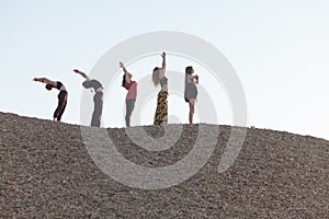 part of yoga sun salutation cycle performed by five women