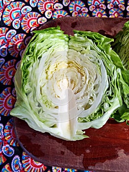 Parted green cabbage with knife.