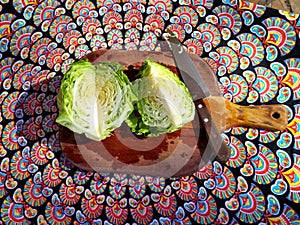 Parted green cabbage with knife