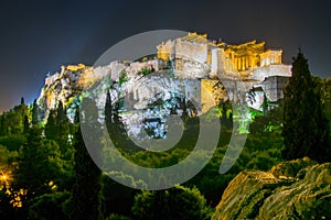 Parthenon and Herodium construction in Acropolis Hill in Athens, Greece shot in blue hour with moon in the sky...IMAGE