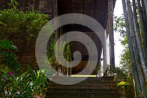 Partial closeup of an old wooden house in a Chinese bamboo forest