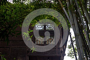 Partial closeup of an old wooden house in a Chinese bamboo forest