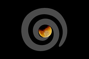 Partial eclipse ends of the moon on the dark night background