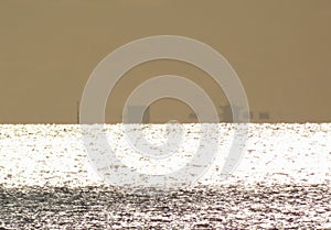 Partial Fata Morgana, bright glittery sea and brown sky photo