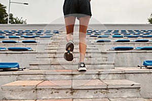 Partial image of sports woman running on stairs