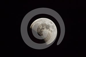 Partial lunar eclipse in summer night over the Judean desert near the town of Mitzpe Ramon in Israel photo