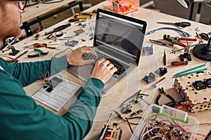 Partial male IT engineer programming code of chip