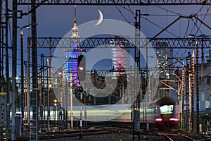 Partial moon over Warsaw city and train junction