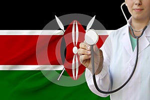 Partial photograph of a doctorâ€™s girl, a nurse with a stethoscope in uniform against the background of the colored national flag