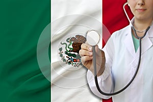 Partial photograph of a doctorâ€™s girl, a nurse with a stethoscope in uniform against the background of the colored national flag