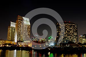 Partial San Diego skyline over water at night