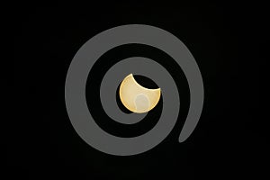 Partial solar eclipse captured against dark sky..