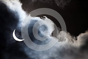 Partial solar eclipse through clouds