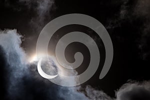 Partial solar eclipse through clouds