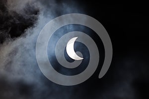 Partial solar eclipse through clouds