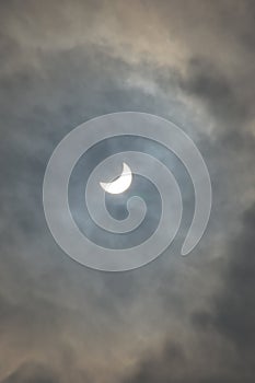 Partial solar eclipse on a cloudy day