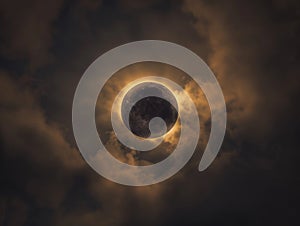 Partial solar eclipse in cloudy sky