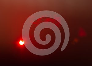 A partial solar eclipse through floppy tape and thin clouds