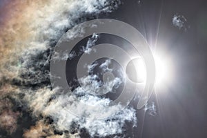 Partial Solar Eclipse with Clouds in the Sky