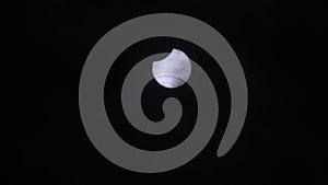 Partial solar eclipse through thin clouds