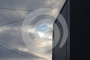 Partial solar eclipse viewed under cloudy skies