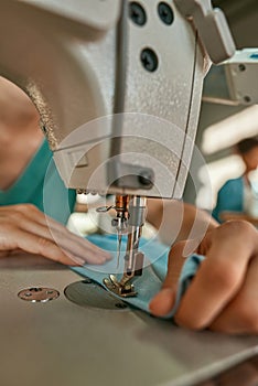 Partial tailor work on sewing machine in atelier