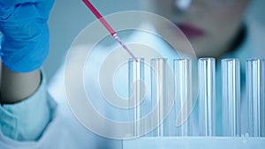 partial view of blurred scientist adding