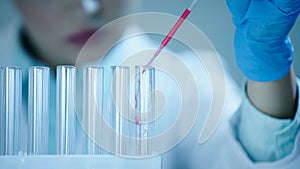 partial view of blurred scientist adding