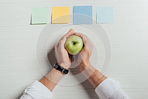Partial view of businessman holding apple